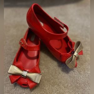 Red mini Melissa shoes with gold bow
